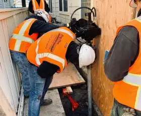 Bay Area Underpinning employees at a jobsite installing helical piers.