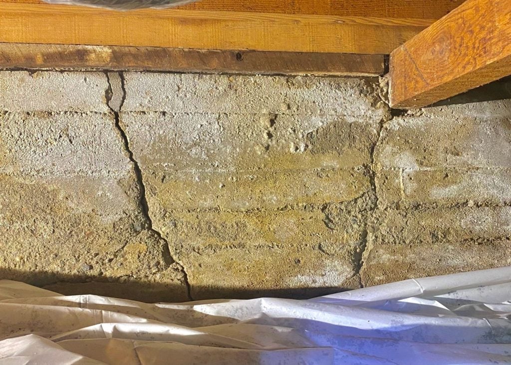 Multiple cracks in crawl space foundation wall.